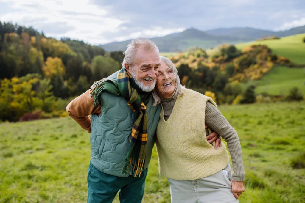 happy senior couple walking in autumn meadow 2022 10 25 21 40 52 utc